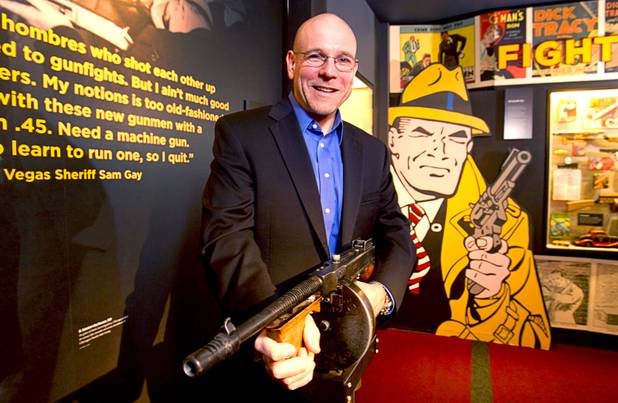 Jonathan Ullman, executive director and CEO of the Mob Museum, the National Museum of Organized Crime and Law Enforcement, poses  by a Tommy gun exhibit at the museum in downtown Las Vegas Wednesday, Feb.13, 2013. The museum celebrates it's first anniversary on Valentine's Day.