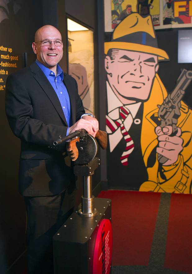 Jonathan Ullman, executive director and CEO of the Mob Museum, the National Museum of Organized Crime and Law Enforcement, poses  by a Tommy gun exhibit at the museum in downtown Las Vegas Wednesday, Feb.13, 2013. The museum celebrates it's first anniversary on Valentine's Day.