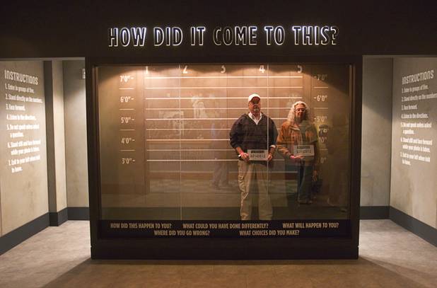 Mike and Marsha Cox of Asheville, N.C. poses in a line-up exhibit at the Mob Museum, the National Museum of Organized Crime and Law Enforcement, in downtown Las Vegas Wednesday, Feb.13, 2013. The museum celebrates it's first anniversary on Valentine's Day.