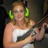 This July 28, 2012, photo provided by Bob MacDuff shows Lindsae MacDuff holding an automatic weapon at the Gun store in Las Vegas after her "shotgun wedding."