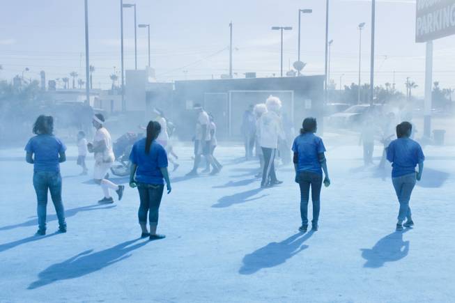 Volunteers are seen waiting in a blue haze for participants to run through the blue stage of the 5K Color Run, Saturday, Feb. 16, 2013. (Photo by Yasmina Chavez)