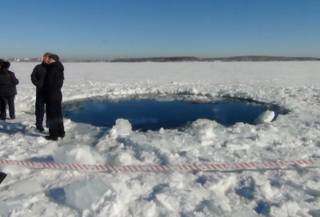 A circular hole in the ice of Chebarkul Lake where a meteor reportedly struck the lake near Chelyabinsk, about 1500 kilometers (930 miles) east of Moscow,  Russia,  Friday, Feb. 15, 2013. A meteor streaked across the sky and exploded over Russias Ural Mountains with the power of an atomic bomb Friday, its sonic blasts shattering countless windows and injuring nearly 1,000 people. 