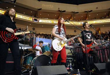 Local rock band The Roxy Gunn Project belts out a tune during a stoppage in play between the Wranglers and the Idaho Steelheads as part of the additional entertainment of the “Midnight Circus” early Monday morning.