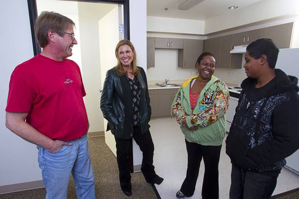 Maria Cuomo Cole, second left, chairman of HELP USA, visits with residents Randy Stotler, an Army veteran, Anita Williams, a Navy veteran and her son Joseph Williams, 13, at the HELP Las Vegas Renaissance Apartments on North Main Street Tuesday, Feb.19, 2013. HELP USA is a national developer of housing for homeless and low-income populations including families, victims of domestic violence, and veterans.