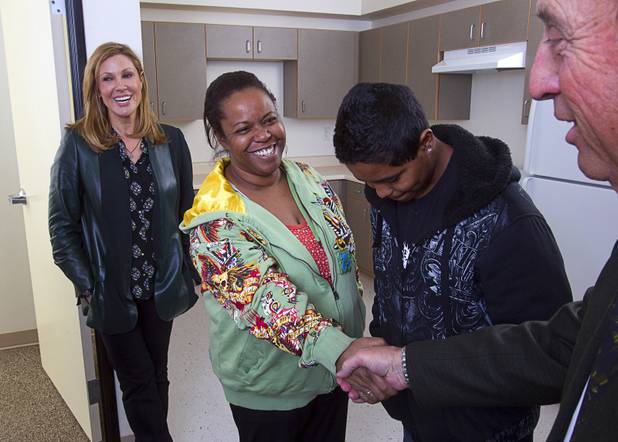 Maria Cuomo Cole, left, chairwoman of HELP USA, smiles as resident and Navy veteran Anita Williams thanks Steve Silverman, regional executive director, at HELP Las Vegas Renaissance Apartments on North Main Street on Tuesday, Feb. 19, 2013. With Williams is her son Joseph Williams, 13. 