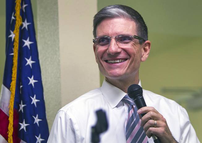 Congressman Joe Heck, R-Nev., smiles as someone's ringtone plays George Thorogood's "Bad to the Bone" during a town hall meeting with constituents at Pacific Pines Senior Apartments in Henderson on Tuesday, Feb. 19, 2013.
