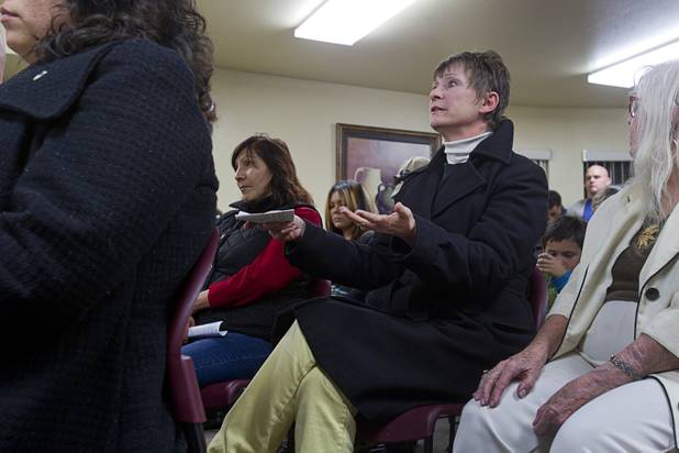 Connie Snyder asks Congressman Joe Heck (R-NV) a question about increasing the national minimum wage during a town hall meeting at Pacific Pines Senior Apartments in Henderson Tuesday, Feb.19, 2013.