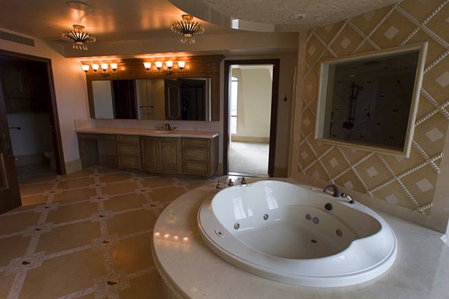 A bathtub is shown in one to the master bedroom's ...