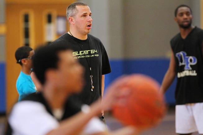 Desert Pines coach Mike Uzan directs his players during practice Tuesday, Feb. 19, 2013.