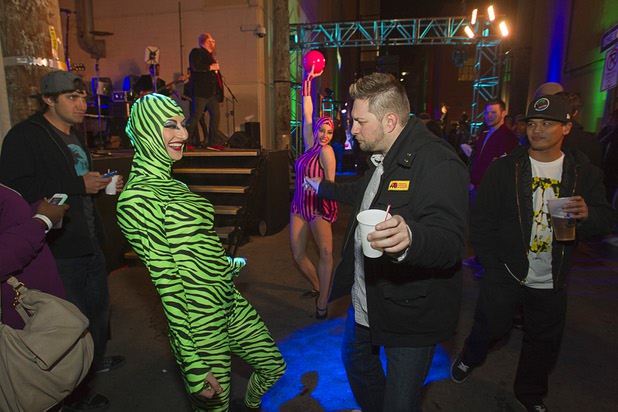 A costumed performer dances with man during the second annual Fashion Alley in downtown Las Vegas Wednesday, Feb. 20, 2013.