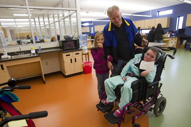 Fred Gundlach poses with his granddaughter Jordyn Foster in the health center of the John F. Miller School, a school which serves students with disabilities and special needs, following an opening ceremony Wednesday Feb. 20, 2013. Another granddaughter, Amanda Sokolik, 7, is at left. The school has been nominated for a national design award.