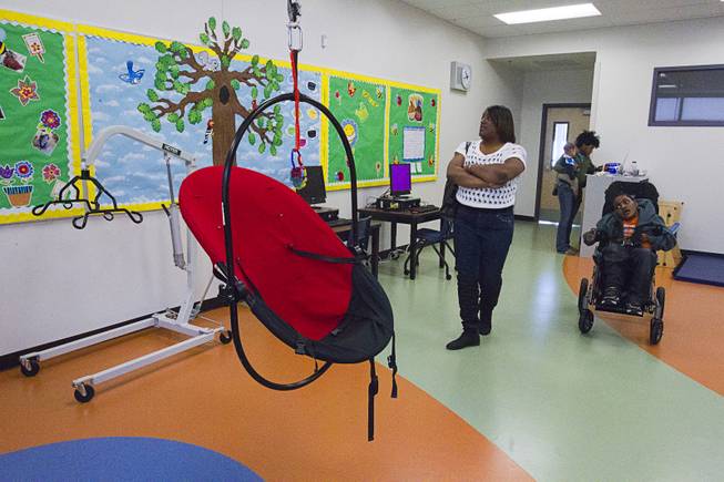 Catrina Parker looks over her son's classroom following an official opening ceremony at the new John F. Miller School, a school which serves students with disabilities and special needs, Wednesday Feb. 20, 2013. The school has been nominated for a national design award.