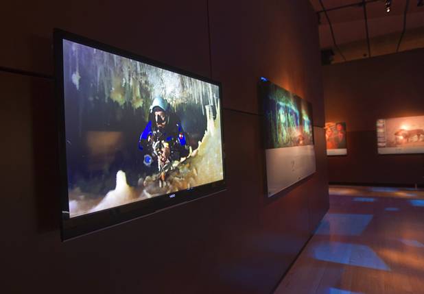 A video documenting an underwater photo shoot is played on a monitor, left, at the Imagine Exhibitions Gallery in the Venetian Wednesday Feb. 20, 2013. The gallery is showing the 50 Greatest Photographs of National Geographic, an exhibit of National Geographics most iconic photos. STEVE MARCUS