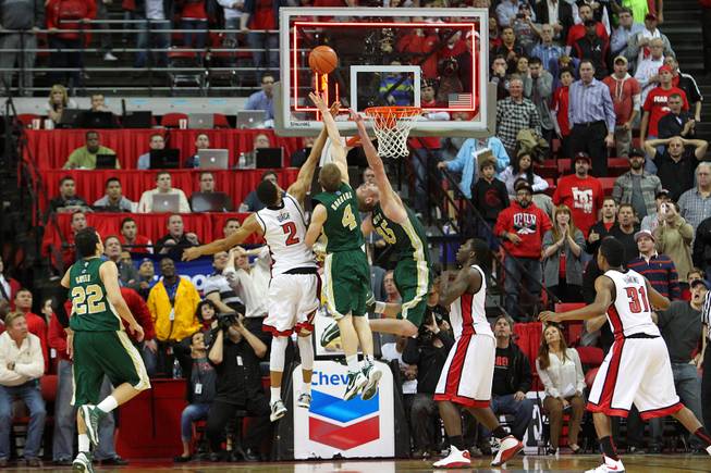 UNLV forward Khem Birch defends Colorado State's Pierce Hornung (4) and Colton Iverson as they try to tip in a shot as the clock expires in their Mountain West Conference game Wednesday, Feb. 20, 2013 at the Thomas & Mack. UNLV won 61-59.
