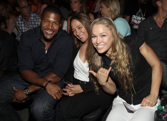 Ronda Rousey, right, poses with Michael Strahan and her mother AnnMaria De Mars at UFC on Fox 4 at Staples Center on Saturday, Aug. 4, 2012, in Los Angeles. 