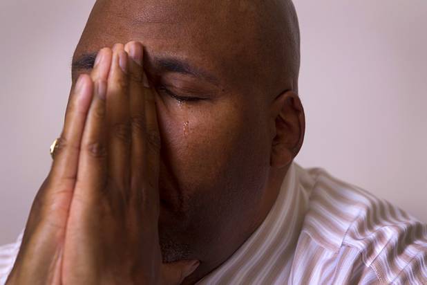 Rudy Gibson cries as he remembers his younger brother Stanley during an interview in his attorney's office in Henderson Thursday, Feb. 21, 2013. Stanley Gibson was killed in an officer-involved shooting in December of 2011.