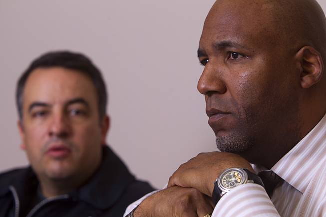 Rudy Gibson, right, listens as his attorney Andre Lagomarsino speaks during an interview in his Lagomarsino's office in Henderson Thursday, Feb. 21, 2013. Stanley Gibson, Rudy's younger brother, was killed in an officer-involved shooting in December of 2011.