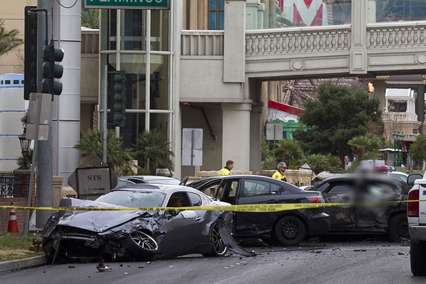 Wrecked cars are shown on Las Vegas Boulevard and Flamingo Avenue as Las Vegas Metro Police investigate a shooting and multi-car accident that left three people dead and three injured on the Las Vegas Strip early Thursday morning, Feb. 21, 2013. EDITOR’S NOTE: This photo has been digitally altered to obscure an image of one of the victims.
