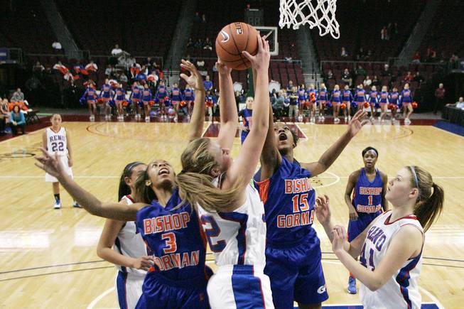 Bishop Gorman's April Rivers, left, and Madison Washington challenge Reno's Morgan McGwire for a rebound during their Division I state championship game Friday, Feb. 22, 2013 at the Orleans. Reno won 52-39.