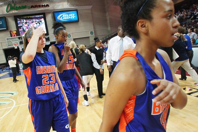 Bishop Gorman's Megan Jacobs, left, Madison Washington and Alaysia Robinson, right exit the court after losing 52-39 to Reno in their Division I state championship game Friday, Feb. 22, 2013 at the Orleans.