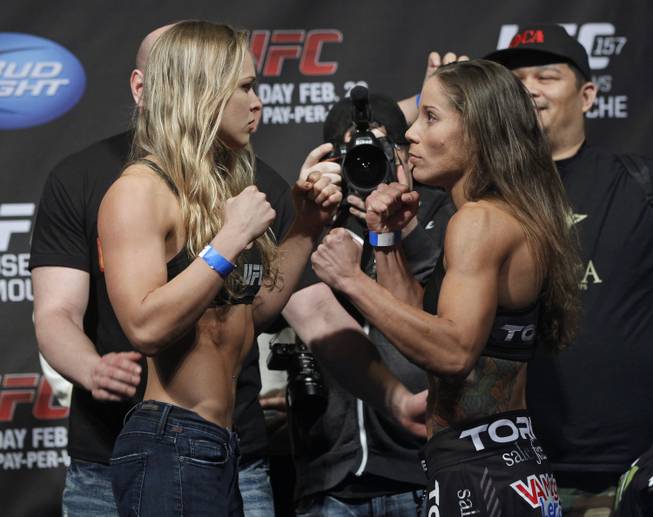 Mixed martial arts fighter UFC bantamweight champion, Ronda Rousey, left, and opponent Liz Carmouche face off at the Honda Center in Anaheim, Calif., Friday, Feb. 22, 2013. Champion Rousey will fight Liz Carmouche in the main event at UFC 157 at the Honda Center on Saturday Feb. 23, in the first women's bout in the UFC promotion's history.
