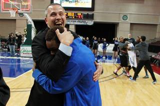 Desert Pines head coach Mike Uzan hugs Terrell Moore after they beat Clark in their Class 1A basketball championship game Saturday, Feb. 23, 2013 at the Orleans Arena. After trailing almost the whole game, Desert Pines came from behind to win 59-57
