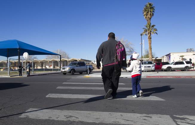 A father and daughter head to school following a rally for Education Awareness Day at Fay Herron Elementary School in North Las Vegas Monday Feb. 25, 2013. Teachers and members of the Clark County Education Association urged lawmakers in Carson City to consider issues with overcrowded classrooms and resources for English language learners. Over 95percent  of the student population at the school is Hispanic, the principal said.
