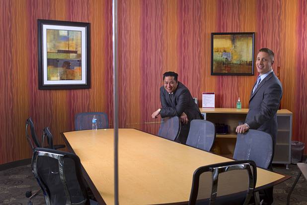 Executive suites managers Leo Agustin, left, and Michael Hatcher pose in a glassed conference room at the Tivoli Village Executive Suites Tuesday, Feb. 25, 2013. Hatcher manages suites on Howard Hughes Parkway. Agustin manages the Tivoli Village property.