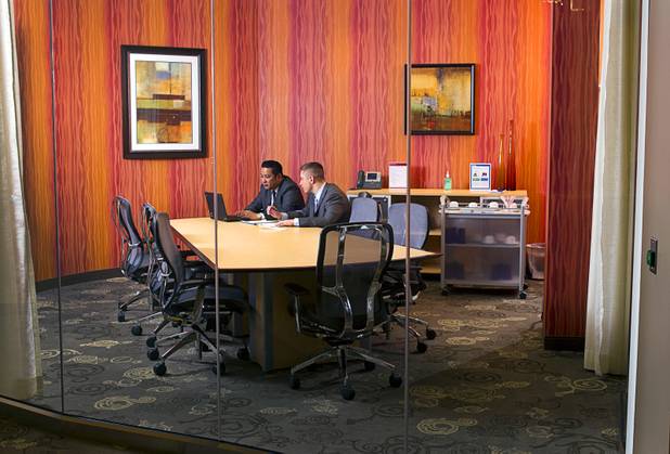 Executive suites managers Leo Agustin, left, and Michael Hatcher work in a conference room at the Tivoli Village Executive Suites Tuesday, Feb. 25, 2013. Hatcher manages suites on Howard Hughes Parkway. Agustin manages the Tivoli Village property.
