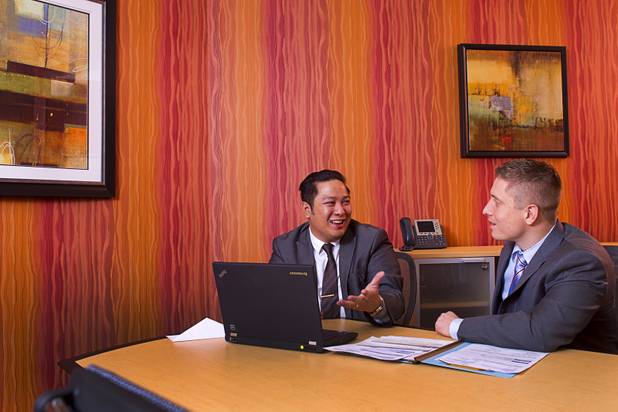 Executive suites managers Leo Agustin, left, and Michael Hatcher work in a conference room at the Tivoli Village Executive Suites Tuesday, Feb. 25, 2013. Hatcher manages suites on Howard Hughes Parkway. Agustin manages the Tivoli Village property.