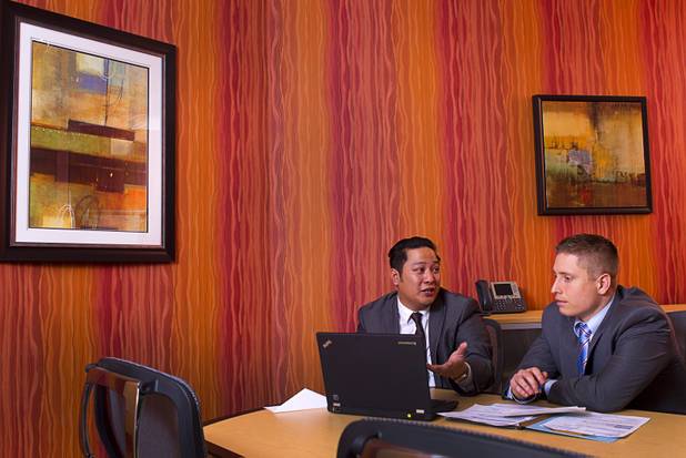 Executive suites managers Leo Agustin, left, and Michael Hatcher work in a conference room at the Tivoli Village Executive Suites Tuesday, Feb. 25, 2013. Hatcher manages suites on Howard Hughes Parkway. Agustin manages the Tivoli Village property.