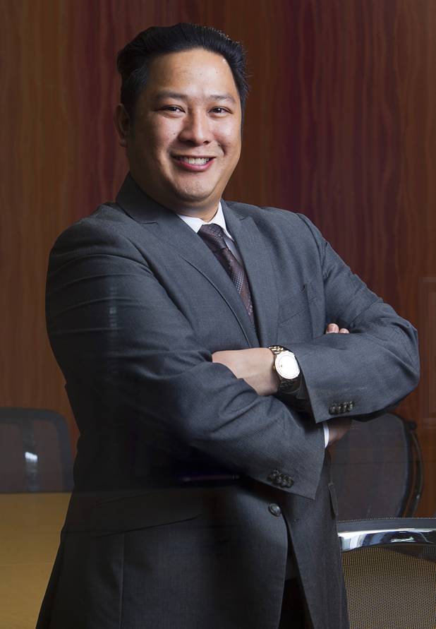 Executive suites manager Leo Agustin poses at the Tivoli Village Executive Suites Tuesday, Feb. 25, 2013.