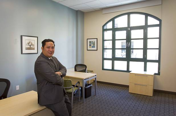 Executive suites manager Leo Agustin poses in an office space at the Tivoli Village Executive Suites Tuesday, Feb. 25, 2013.