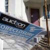 An auction sign for a foreclosed home in Las Vegas bends in the wind, Nov. 17, 2010.