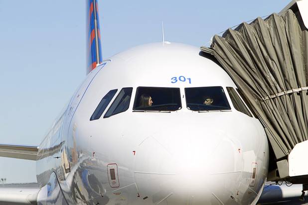 Allegiant Air pilots Keelyn Brown, left, and Matt Rudich look over the cockpit of a new Allegiant Airbus A319 passenger jet at McCarran International Airport Thursday, Feb. 28, 2013. The new jets are much more fuel efficient than the company's current jets.