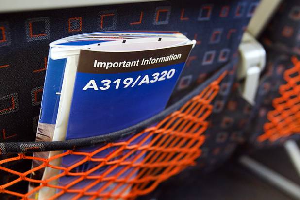 Information is shown in a back seat pocket in a new Allegiant Air Airbus A319 passenger jet at McCarran International Airport Thursday, Feb. 28, 2013. The new jet is more fuel efficient than the company's current jets.