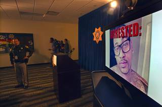 A photo of Ammar Harris is displayed on a video monitor before a news conference at Las Vegas Metropolitan Police headquarters Thursday, Feb. 28, 2013 after Harris was arrested in North Hollywood. Harris, 26, is the suspect of last Thursday's shooting and accident on the Las Vegas Strip that left three people dead.