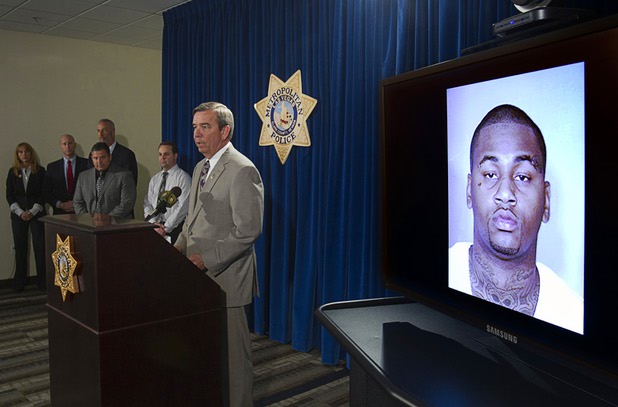 Sheriff Douglas Gillespie responds to a question during a news conference at Las Vegas Metropolitan Police headquarters Thursday, Feb. 28, 2013 after Ammar Harris was arrested in North Hollywood. Harris, 26, shown in a mugshot at right, is the suspect of last Thursday's shooting and accident on the Las Vegas Strip that left three people dead.
