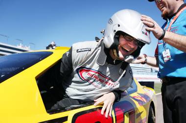 John Katsilometes gets into his race car to drive at the Richard Petty Driving Experience at Las Vegas Motor Speedway on Friday, March 1, 2013.