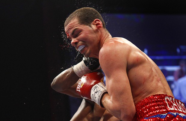 WBA lightweight champion Richard Abril of Cuba takes a punch from Sharif Bogere of Uganda during their title fight at the Hard Rock Hotel in Las Vegas, Nevada March 2, 2013. Abril retained his title with a unanimous decision victory.