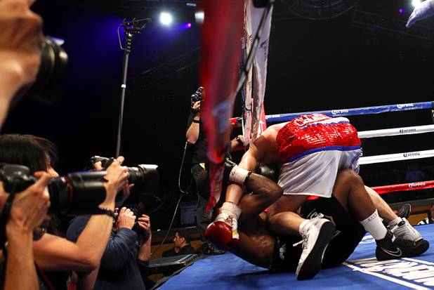 WBA lightweight champion Richard Abril of Cuba falls on Sharif Bogere of Uganda during their title fight at the Hard Rock Hotel in Las Vegas, Nevada March 2, 2013. Abril retained his title with a unanimous decision victory.