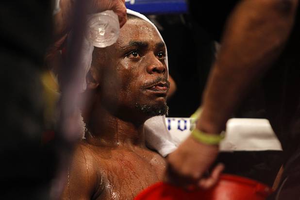 Sharif Bogere of Uganda is treated by members of his corner between rounds during his title fight against WBA lightweight champion Richard Abril of Cuba at the Hard Rock Hotel in Las Vegas, Nevada March 2, 2013. Abril retained his title with a unanimous decision victory.