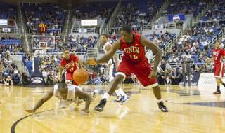 UNLV's Anthony Bennett and a UNR player go after the ball Saturday, March 2, 2013, during the Rebels' 80-63 victory at the Lawlor Events Center.