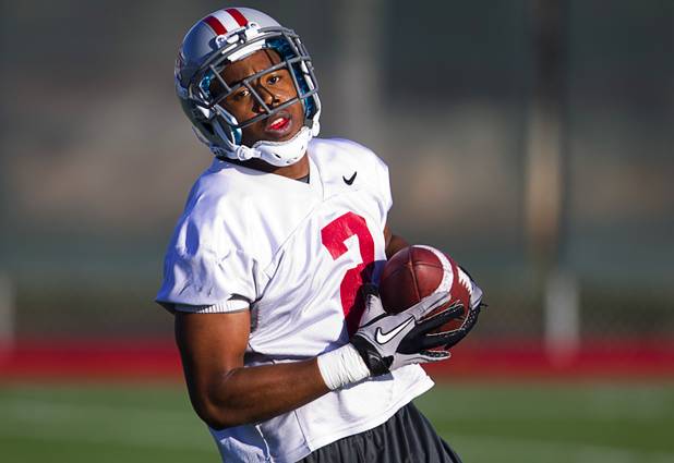 Running back Adonis Smith carries the ball during practice at Rebel Park at UNLV Monday, March 4, 2013.