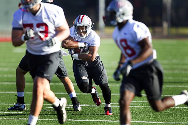 Running back Adonis Smith carries the ball during practice at Rebel Park at UNLV Monday, March 4, 2013.