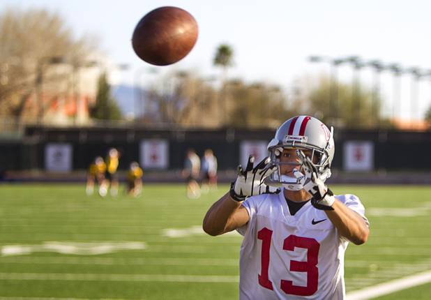 Wide receiver Jonathan James catches a pass during practice at Rebel Park at UNLV Monday, March 4, 2013.
