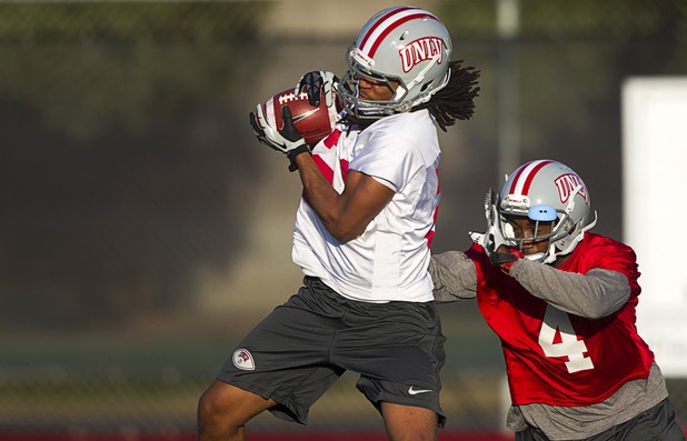 Wide receiver Taylor Spencer is covered by defensive back Sidney Hodge as he pulls in a pass during practice at Rebel Park at UNLV Monday, March 4, 2013.