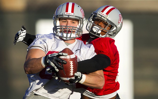 Tight end Tyler Bergsten is covered by defensive back Mike Horsey as he pulls in a pass during practice at Rebel Park at UNLV Monday, March 4, 2013.