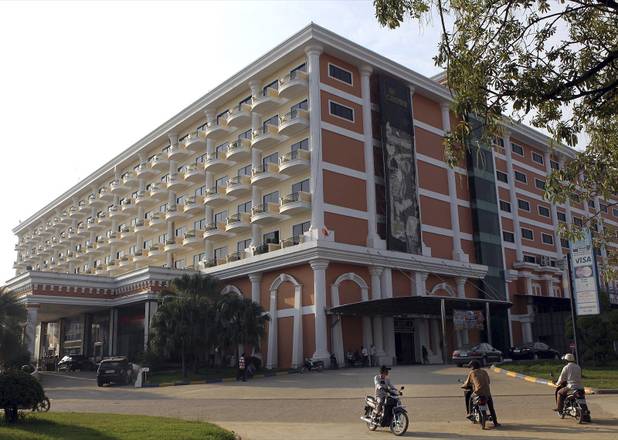 Cambodian motorcycle taxi drivers wait for customers outside the Genting Crown Casino in Poipet, Cambodia, Dec. 9, 2012. 