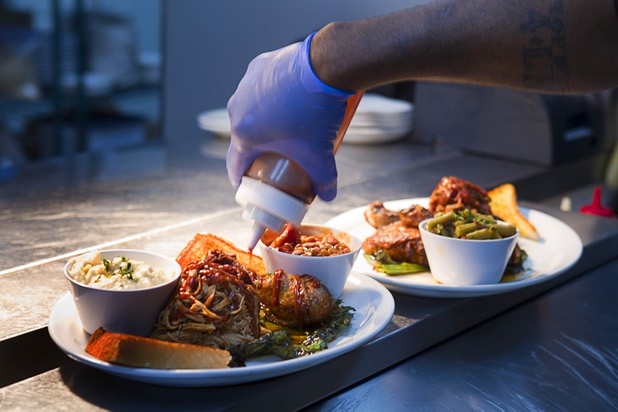 Chef and owner Jimmy Cole prepared an order in the kitchen at Top Notch Barbeque at Serene and Eastern avenues Tuesday, March 5, 2013. The restaurant is the same building but is separate from the Doc Holliday's tavern.